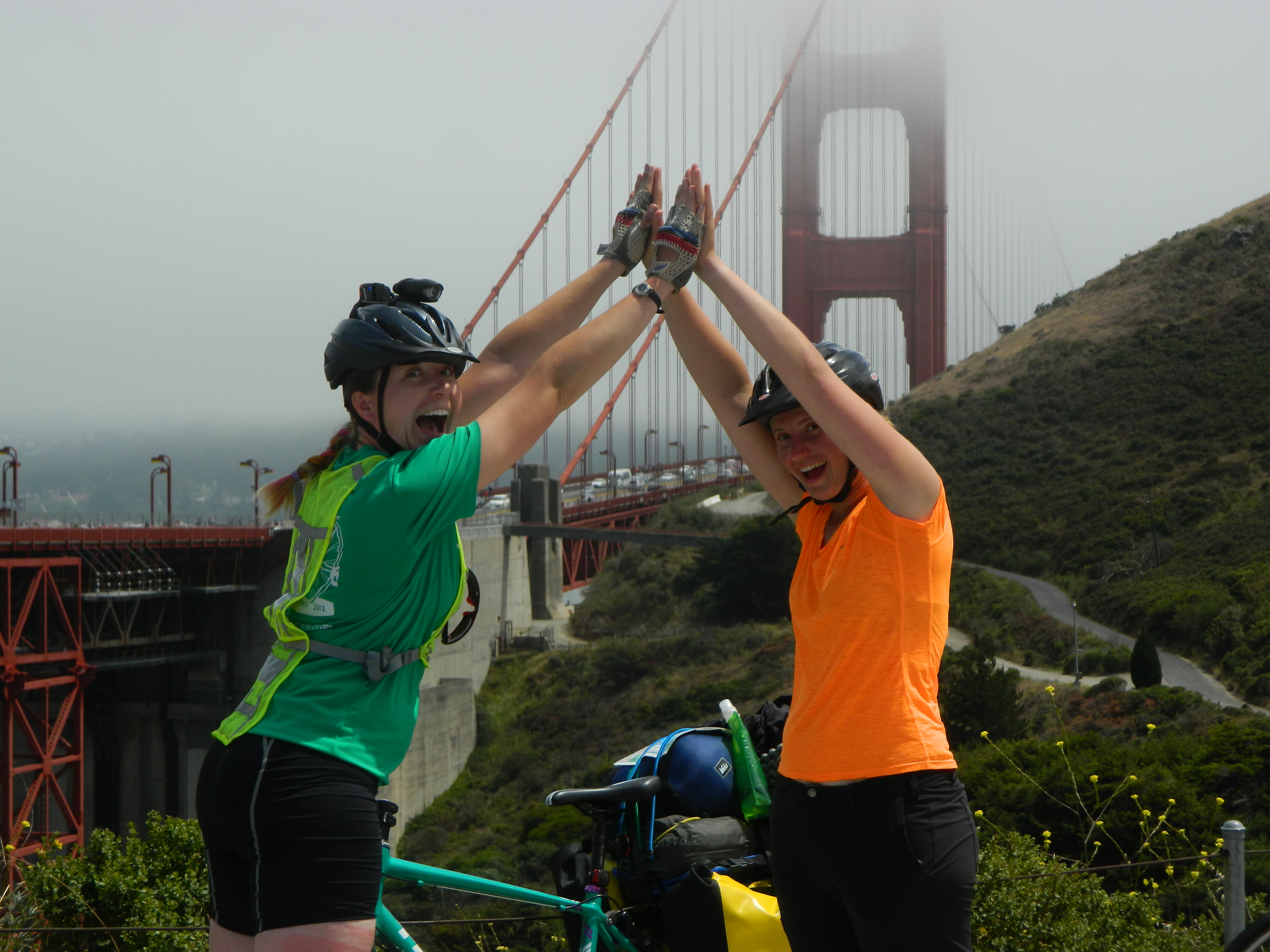 veronica and kayla high five in front of the san francisco bridge